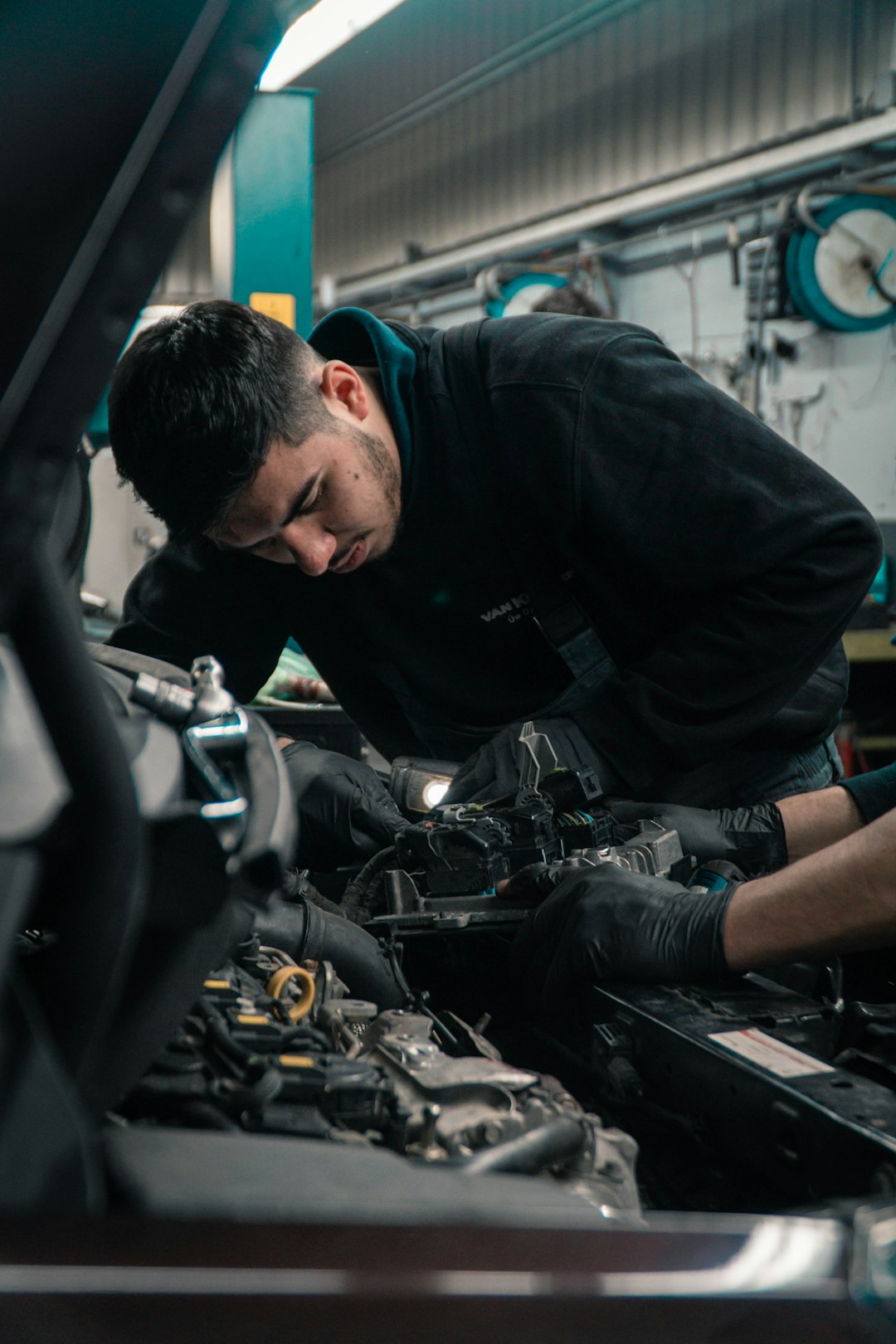 Engine oil dipstick showing dark black oil indicating car needs oil change - 10 warning signs